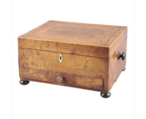 A WALNUT WORKBOX 19th century, with ebony turned handles to the sides and an ivory handle to the drawer, terminating on bun f