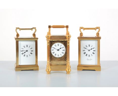 THREE 20TH CENTURY BRASS CARRIAGE CLOCKStwo with reeded corners and brass bracket bases, the taller, 15cm high, the third wit