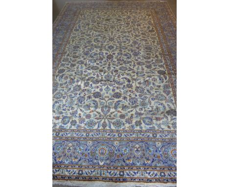 A Kashan, hand knotted, woollen rug with caucasian ground, approximately 375cm x 275cm, some light wear 