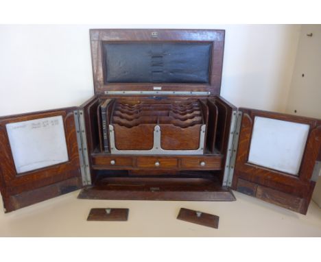 A 1930s oak Army and Navy stationery cabinet, approximately 29cm x 43cm x 22cm, with letter rack and cubby holes, including a