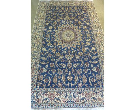A fine Nain, hand knotted, woollen rug with blue ground, approximately 250cm x 152cm, some light wear otherwise in good condi