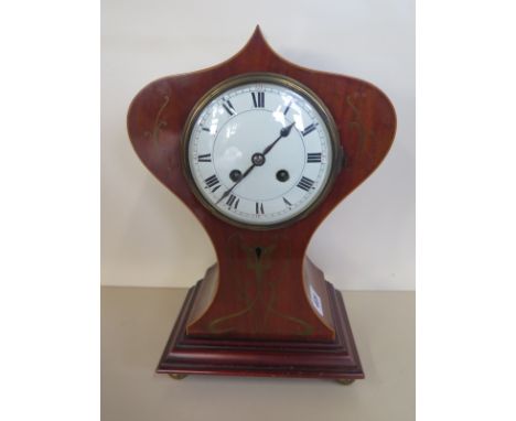 A brass inlaid mahogany Art Nouveau balloon shaped mantle clock, striking on a going, 33cm H, some small wear to dial, runnin