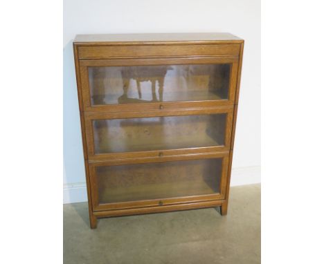 A circa 1920s light oak globe Wernicke style three tier stacking book case, approx 110cm H x 87cm W x 24.5cm deep 