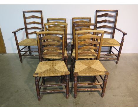 A matched set of eight 19th Century Wigan type ash and elm ladder back chairs, with rush seats, including two carvers, with r