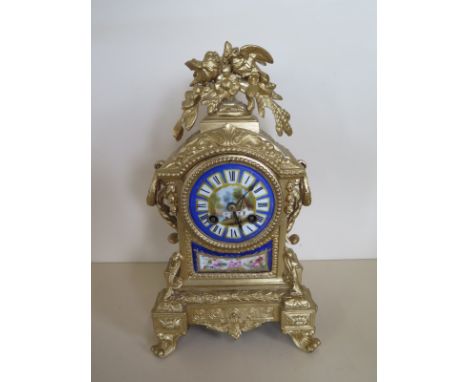 An ormulu and porcelain mantle clock, striking on a bell, 31cm tall, case has been repainted, running and strikes - no key 