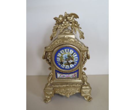 An ormulu and porcelain mantle clock, striking on a bell, 31cm tall, case has been repainted, running and strikes - no key 