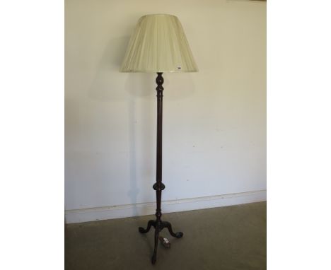 A mahogany standard lamp with cream shade on a carved tripod base -PAT tested and in  working order, 185cm tall 