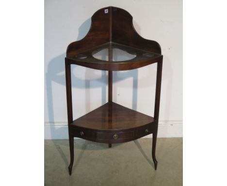 A late 18th Century mahogany corner wash stand with a base drawer on French Hepplewhite feet, in good condition with glass sh