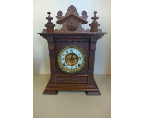 A Victorian oak cased 8 day movement table clock, with Arabic dial, enamel chapter ring, approximately 38cm high, not current