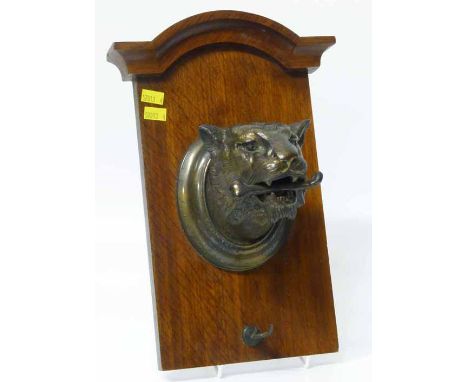 Bronze tiger head mounted on oak plaque probably for a dinner gong. No condition reports for this sale