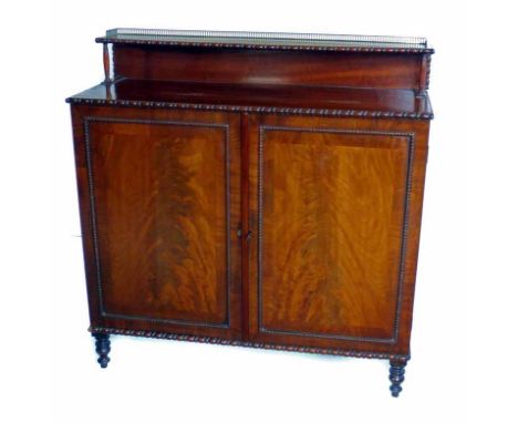 Victorian mahogany side cabinet.  Brass galleried shelf above rectangular top with egg and bobbin mould bead.  Base with two 