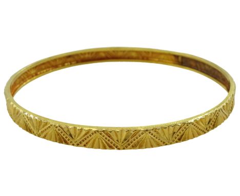 Middle Eastern 21ct gold bangle with engraved decoration
