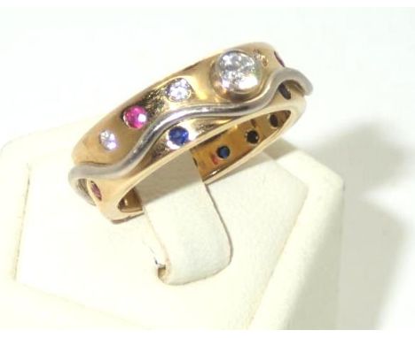 Excellent quality 18ct white and yellow gold heavy gauge band set with a large raised diamond and a multitude of rubies, sapp