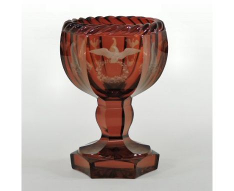 A 19th century Bohemian ruby glass vase, of faceted pedestal shape, finely etched with birds and flowers, below a ropetwist b