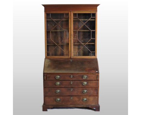 A George III mahogany bureau bookcase, the upper section having a moulded cornice and enclosed by a pair of astragal glazed d