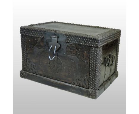 An 18th century Chinese ebonised hardwood iron bound and studded trunk, with pierced ironwork decoration, on a plinth base, 9