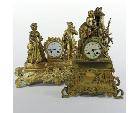 A 19th century French gilt spelter figural mantel clock, the ornate scrolled case surmounted by two figures, having a white e