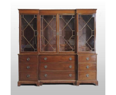 A 19th century mahogany inverted breakfront library bookcase, having a moulded cornice, the upper section fitted with shelves