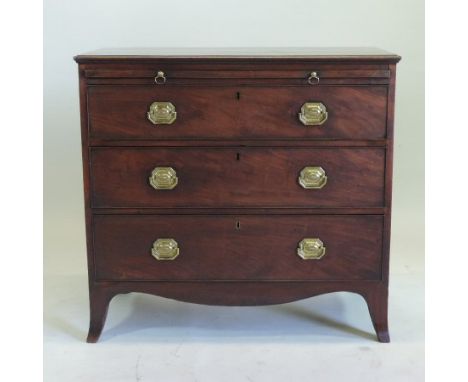 A George III mahogany bachelor's chest, fitted with a brushing slide, over three long graduated drawers, on swept bracket fee