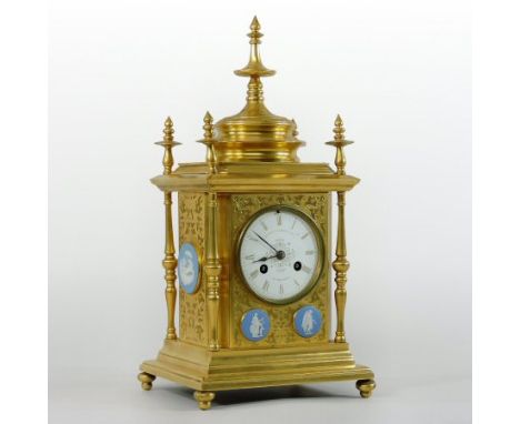 A 19th century gilt metal mantel clock, the engraved case mounted with blue jasper roundels, the 7.5cm dial showing Roman num