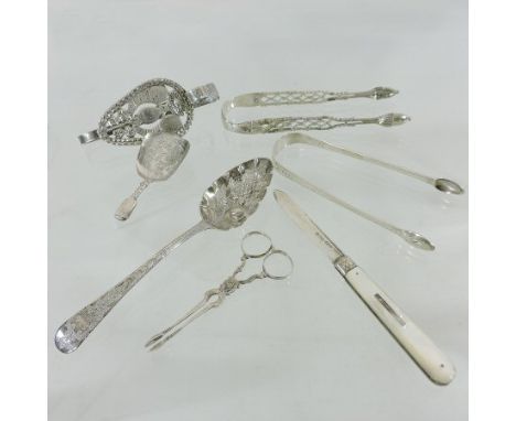 A pair of George III silver sugar tongs, with bright cut decoration, 13cm long, together with another pair, a caddy spoon, a 