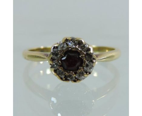 An 18 carat gold ruby and diamond cluster ring