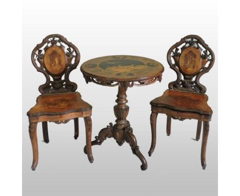 A Swiss carved walnut and marquetry hunting lodge table, the hinged top above a tripod base, 61cm, together with a matching p