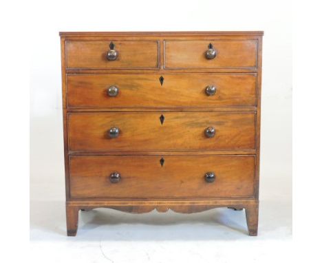 A late George III mahogany and inlaid chest, containing two short over three long drawers, on bracket feet, 103cm