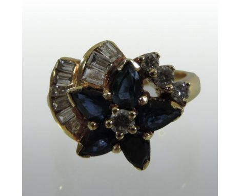 An unmarked sapphire and diamond cluster ring, of asymmetric flowerhead design