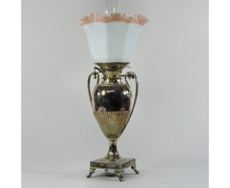 An early 20th century silver plated oil lamp, with a frilled milk glass shade, the reservoir in the form of an urn, stamped H