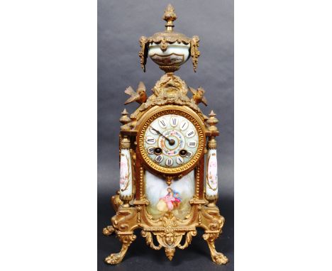 A 19th Century French ormolu clock having a porcelain urn top with floral painted cartouche with ormolu mounts throughout. Be