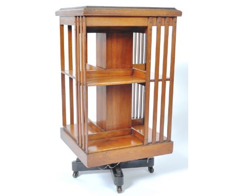 An Edwardian mahogany revolving library bookcase of typical form. Comprises two tiers with slatted section, stepped top all r