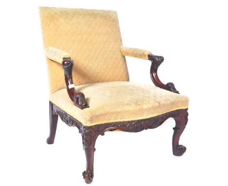 A 19th Century carved Gainsborough armchair in the manner of Chippendale. The chair having square back with cushioned elbow r