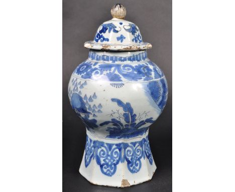 An 18th Century English Delft tin glazed earthenware vase decorated in the Chinese taste. The vase with bell cover finial lid