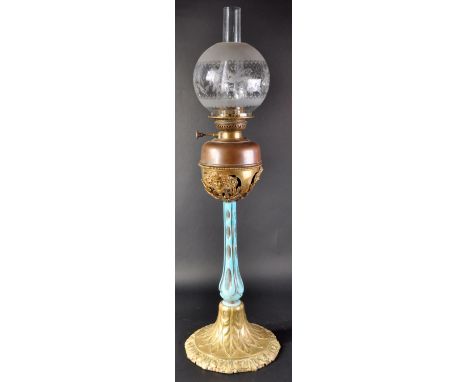 A 19th Century Victorian Art Nouveau oil lamp stand having a classical ormolu bronze oil lamp holder with cherub face masks a