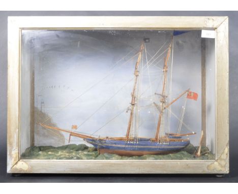 A 19th Century cased model of a clipper / scoop ship boat. The model set on scrunched cloth sea base. The detailed model comp