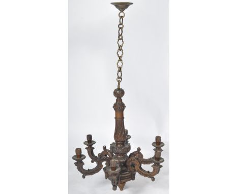 An early 20th Century carved walnut hanging light chandelier. The lamp being set on a long ring chain with central carved col