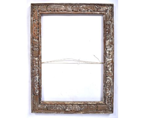 A 19th Century George III carved wood portrait frame of rectangular form having a cushioned frame with carved floral decorati