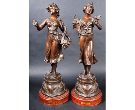 A pair of 19th Century French spelter figures depicting classical ladies in full garments with one lady carrying a basket of 