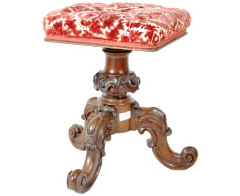 A 19th Century mahogany piano stool having a square cushioned top with buttoned floral upholstery raised on a caved scroll co