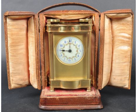 A 20th Century brass cased carriage clock having a floral painted circular dial with Arabic numeral chapter ring with brass b