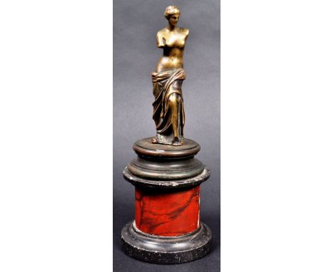 A 19th Italian Grand Tour bronze and marble figurine depicting the Venus De Milo. The bronze figure modelled on a black and r