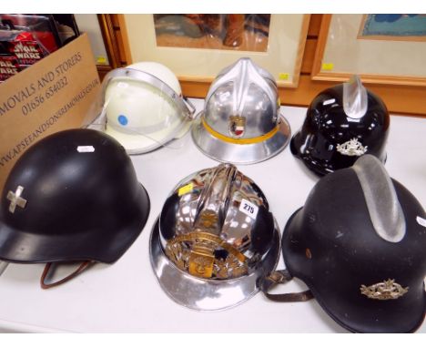 SIX VARIOUS EUROPEAN FIRE BRIGADE HELMETS including Swiss Civil Defence fire helmet, French reproduction helmet, Austrian Hel
