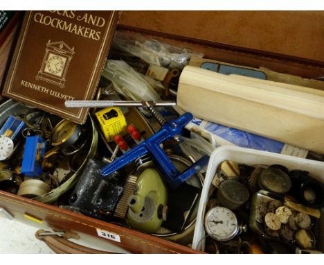 COLLECTION OF WATCH MAKERS WORKSHOP ITEMS contained within a suitcase and two boxes, including watch parts, tools, packets of