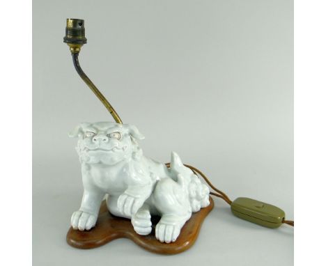 CHINESE CHENIN BLANC DOG OF FO TABLE LAMP in seated position with front paw raised, mounted to a wooden base, lighting attach