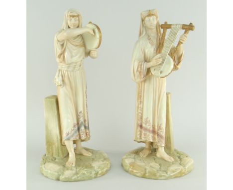 PAIR OF JAMES HADLEY ROYAL WORCESTER PORCELAIN BLUSH EGYPTIAN MUSICIAN FIGURES both standing against a plinth, gentleman play