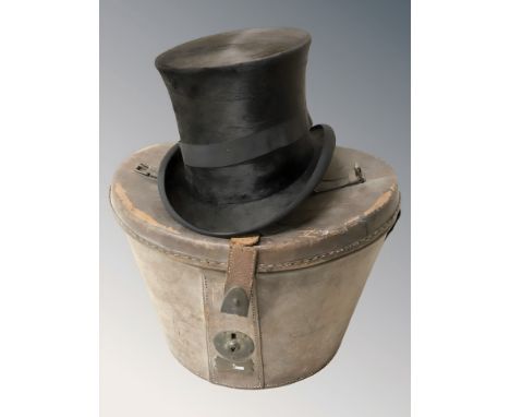 A gent's black silk top hat by A N Wilkinson, Lincoln, in leather case.