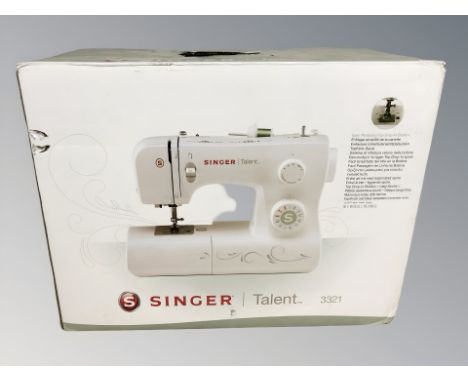A Singer Talent 3321 sewing machine in box.