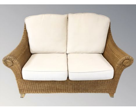 A wicker three piece conservatory suite, settee 150 cm wide.