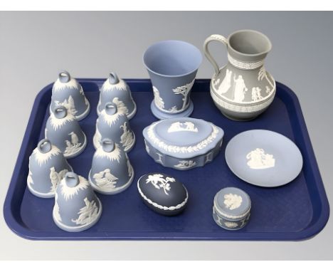 A group of Wedgwood blue and white jasperware bells, similar trinket box, beaker, further jasperware items. 